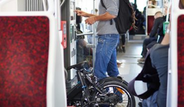 Homem com bike em metro em 5 vantagens da bicicleta dobravel