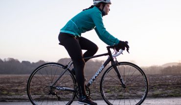 Mulher pedalando em estrada em treinamento de ciclismo para mulheres2